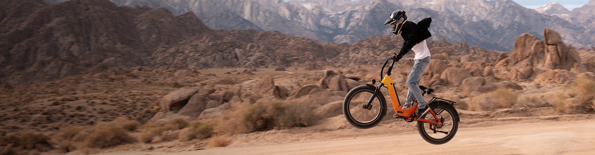 Rider doing a wheelie on a Heybike full suspension ebike