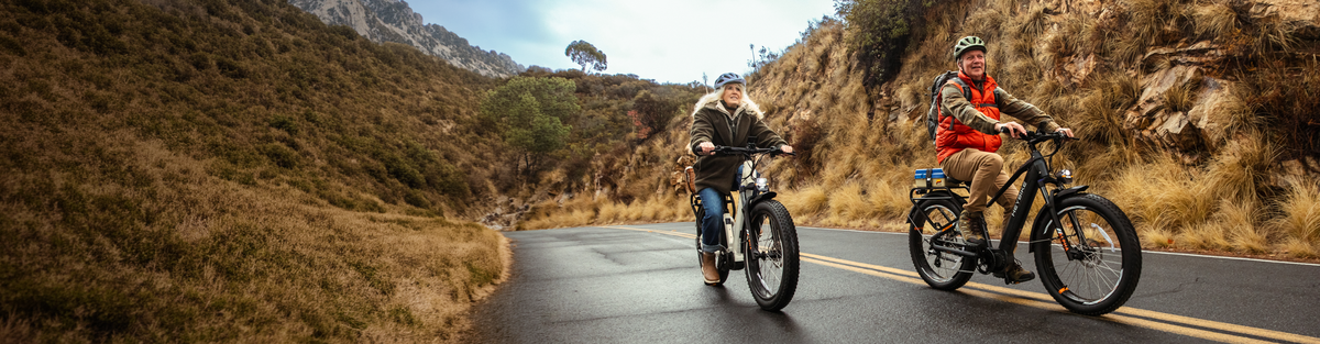 Heybike long range ebikes ridden separately by a man and woman on a road
