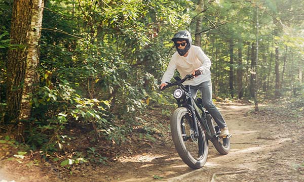A man is riding a Brawn ebike off-road.