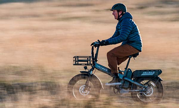 A man is riding a Mars 2.0 electric bike in the wild