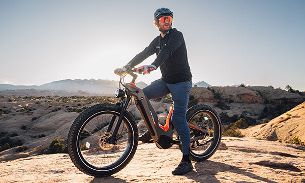 a man is riding mid-drive electric bike outside