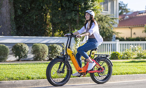 A woman is riding a Horizon step-through e-bike on the road