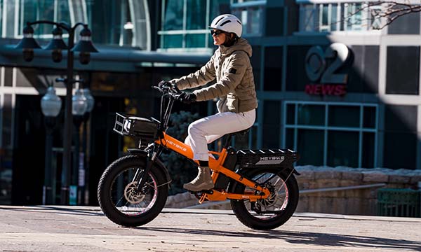 a girl is riding Mars 2.0 big tire ebike on the city