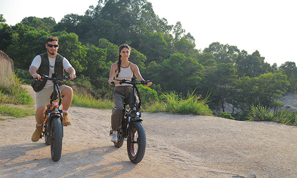 a couple are riding Mars 2.0 fat tire folding ev bike outside