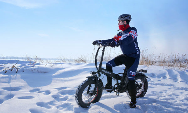 A man is riding a Heybike Mars e-bike in the snow