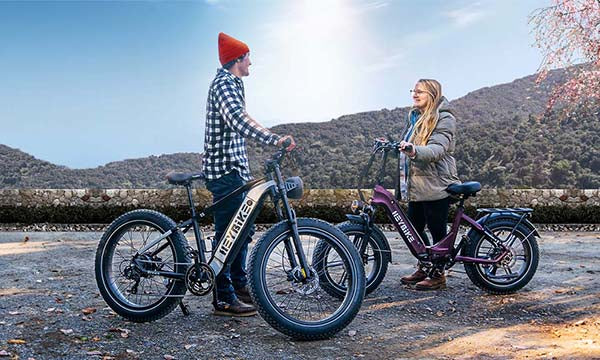a young couple are riding electric bikes outside