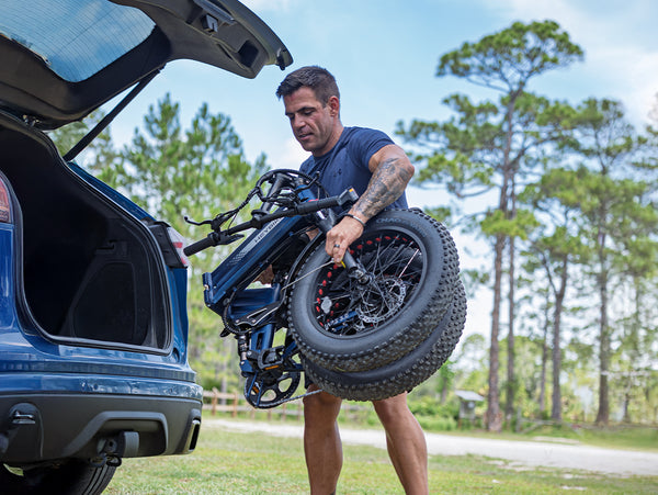 Rider loading a folded Heybike Mars 3.0 into a vehicle