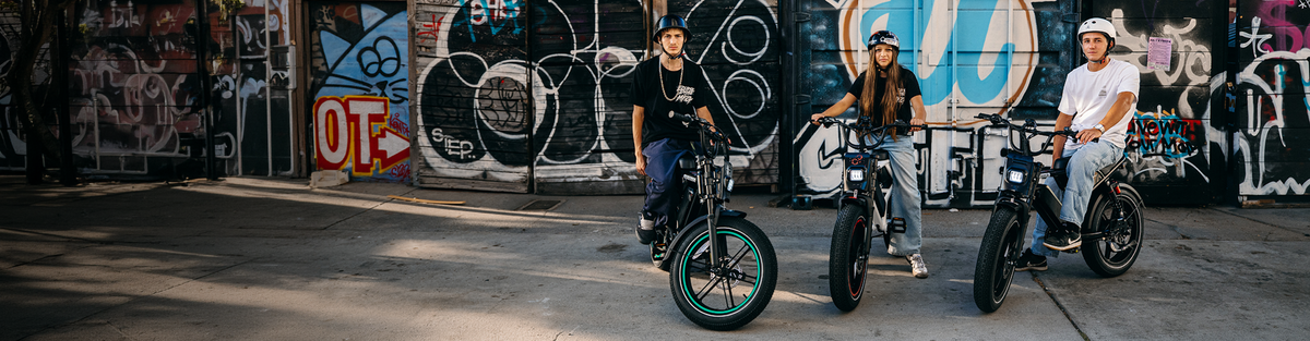 Three young riders wearing helmets on Heybike Titan moped style ebikes